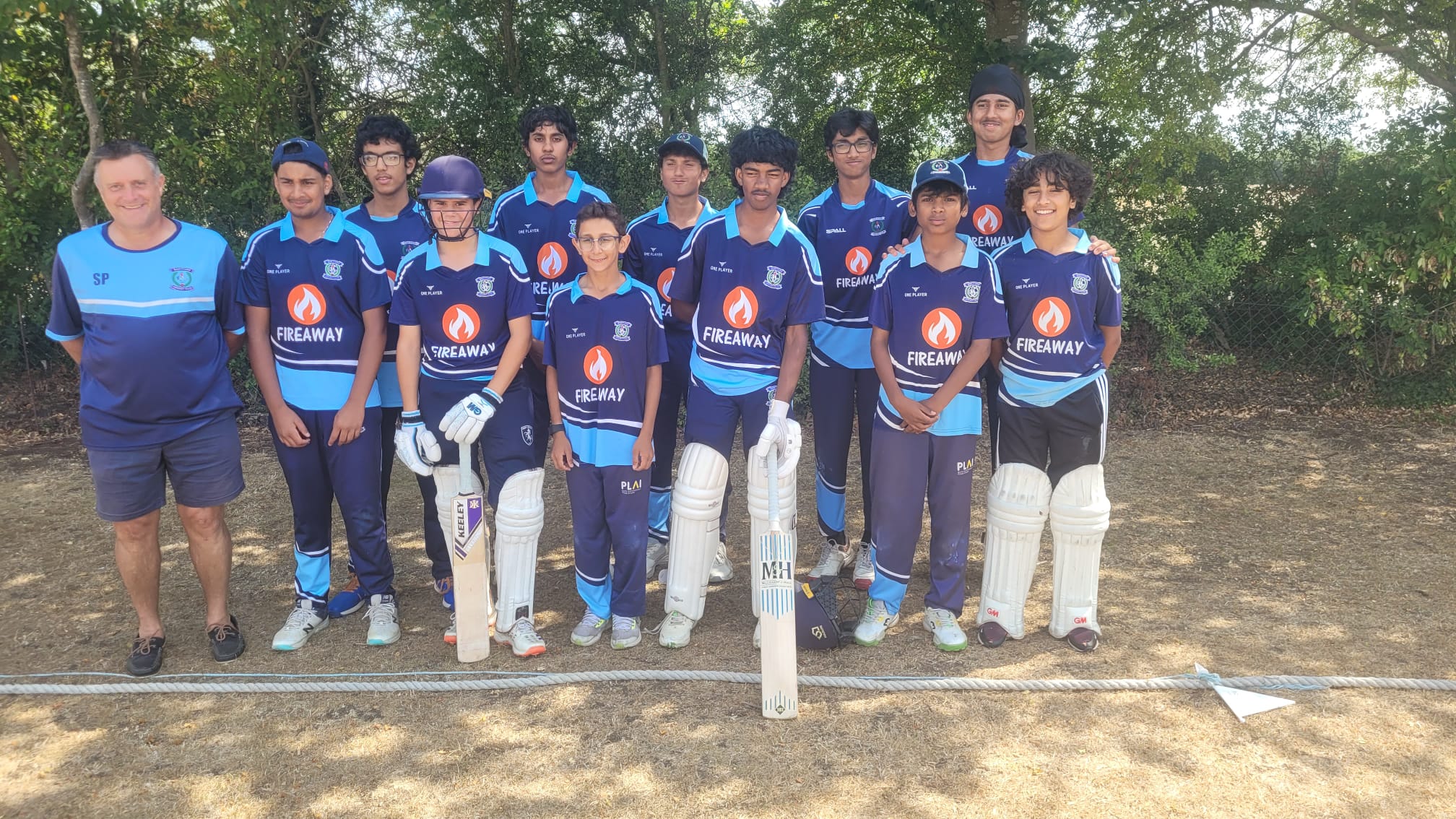 U15s A team squad photo celebrating their NKJL Division 1 championship, with players in Dartford Cricket Club blue kit and manager Shaun